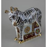 A Royal Crown Derby Imari porcelain paperweight of a zebra, with gold stopper