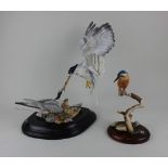 A Sheratt and Simpson model of a kingfisher on a branch 23cm high including base, together with a