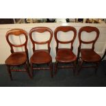 A set of four Victorian balloon back chairs with hard seat on turned front legs (a/f)