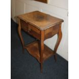 A 19th century walnut sewing table with serpentine shaped rising top enclosing compartments,