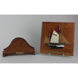 A carved wooden letter rack with plaque 'From the teak of HMS Iron Duke Admiral Jellicoe's Flag Ship