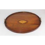 An Edwardian mahogany oval tray with central shell motif and two brass carrying handles 55cm