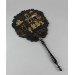 A Chinese lacquered fan decorated with figures and building 42cm (a/f)