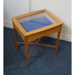 A light oak vitrine display case with rising glazed top on chamfered legs, 48cm