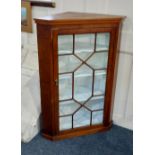 A 19th century oak hanging corner cabinet with panelled glazed door enclosing three shelves, 68cm