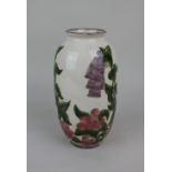 A Cobridge stoneware vase decorated with foxgloves and berries on cream ground 22cm high