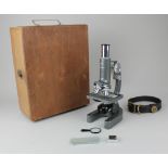 A Regent microscope 40X - 1200X, cased (extra contents missing), together with an Orvis leather