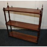 A set of three tier wall shelves with four baluster supports and two brass finials, 60cm
