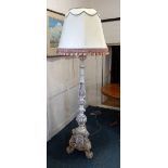 A white painted carved wooden standard lamp, the column acanthus carved and fluted on a triform base