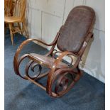 A bentwood rocking chair with brown patchwork leather upholstered back and seat