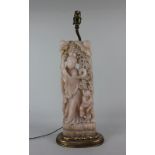 A Chinese carved soapstone model of a woman and child converted to a table lamp, on gilt base 52cm