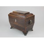 A 19th century rosewood tea caddy with lion mask ring handles, on brass paw feet 20.5cm (a/f)