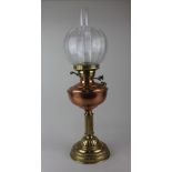 A Victorian copper and brass oil lamp with globular etched glass shade 63cm high including funnel
