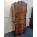 A walnut bowfront chest on chest shaped cornice and five drawers on base with slide, two short and