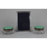 A pair of George V silver and green guilloche enamel lidded circular glass dressing table jars maker