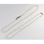 A 'rice' pearl necklace with sapphire and diamond clasp