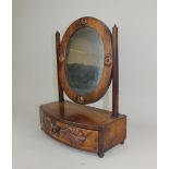 An oval dressing table mirror on box base with shell mounts, (a/f) 33cm