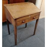 A George III oak desk with sloping top enclosing interior of two small drawers and compartments,