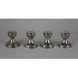 A set of four modern silver dwarf candlesticks with reeded rims on circular loaded bases, Birmingham