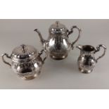 An Orfevrerie Gallia silver plated three piece tea set baluster form with embossed scroll and