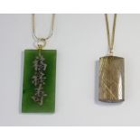 A nephrite jade pendant, and a rutilated quartz pendant, with two neckchains, lengths 60cm and 45cm,