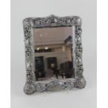 A Victorian silver dressing table mirror pierced scroll frame with plaques of winged angel heads (