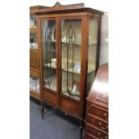 An Edwardian inlaid mahogany display cabinet with two glazed doors and three shelves, on tapered