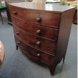 A 19th century mahogany bowfront chest of two short over three long drawers with turned knob handles