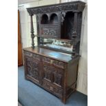 A 19th century Flemish style carved oak dresser with raised mirror back and central cupboard flanked