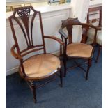 A Victorian mahogany inlaid elbow chair, pierced and carved back splat with curved arms and oval