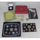 Four Royal Mint British coin sets, to include a Millenium Five Pound coin and United Kingdom 2007