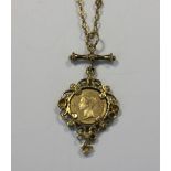 A small coin in pendant mount on yellow metal chain