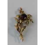 A garnet flower brooch, set in 9ct gold, gross weight 7.4g