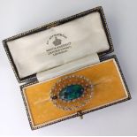 An opal and diamond oval brooch, in an openwork setting, set in white metal, in a Mappin & Webb