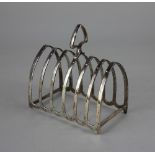 A George V silver toast rack six divisions with central handle, maker Barker Brothers, Chester 1924,