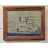 A 19th century woolwork picture of a three-masted ship, the glazed frame faintly stamped 'Museums
