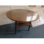 A George III oak circular side table on three sloping legs with triangular platform stretcher, 83cm