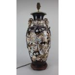 A Japanese ceramic baluster vase converted to a table lamp decorated with warriors amongst