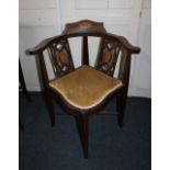 An Edwardian inlaid mahogany corner chair with pierced splats and upholstered seat on splayed legs