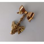 A 9ct gold elephant's head charm, together with a 9ct rose gold bow brooch with swivel clasp,