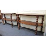 A pair of Victorian mahogany buffets or console tables each with two serpentine shelves on barley