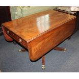 A 19th century mahogany crossbanded Pembroke table with two drawers on turned pedestal support to