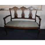 A Victorian mahogany inlaid salon settee, scrolling foliate and floral decoration, with three vase