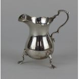 A modern Georgian style silver cream jug baluster shape on three paw feet, maker J B Chatterley &