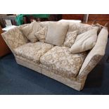 A Knole style sofa drop down sides with acorn shaped finials, upholstered in cream damask, approx