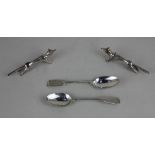 A pair of silver plated Fox character knife rests and two teaspoons