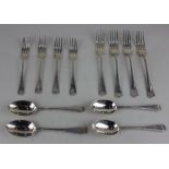 A matched set of four George V and later silver Old English pattern dessert spoons four dessert