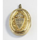 A Victorian yellow metal oval locket with engraved decoration and initials 'EBB' (a/f)