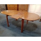A mid 20th century extending dining table by repute from Heals of London, oval shape with two