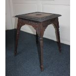 An Indian carved hardwood occasional table, the square top with border of buildings and birds